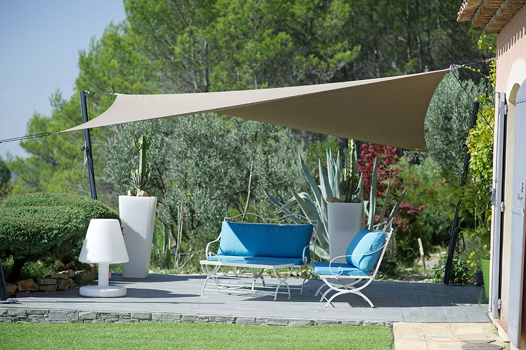 shade sail canopy with forest background